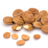 A group of apricot kernels with some cracked open to reveal the inner seeds.